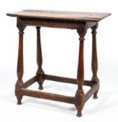 An 18th century oak stool,