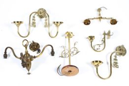A collection of brass lights, a table lamp and various wall lights,