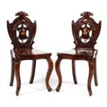 A pair of early 19th century mahogany hall chairs,