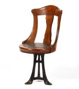 An Edwardian oak captain's chair, with arched top rail and vase-shaoped splat,