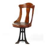 An Edwardian oak captain's chair, with arched top rail and vase-shaoped splat,