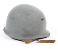 A Second World War style US United States Army M1 fixed bale steel combat helmet