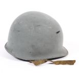 A Second World War style US United States Army M1 fixed bale steel combat helmet