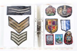 A collection of approximately 160 military and police cloth badges and others,