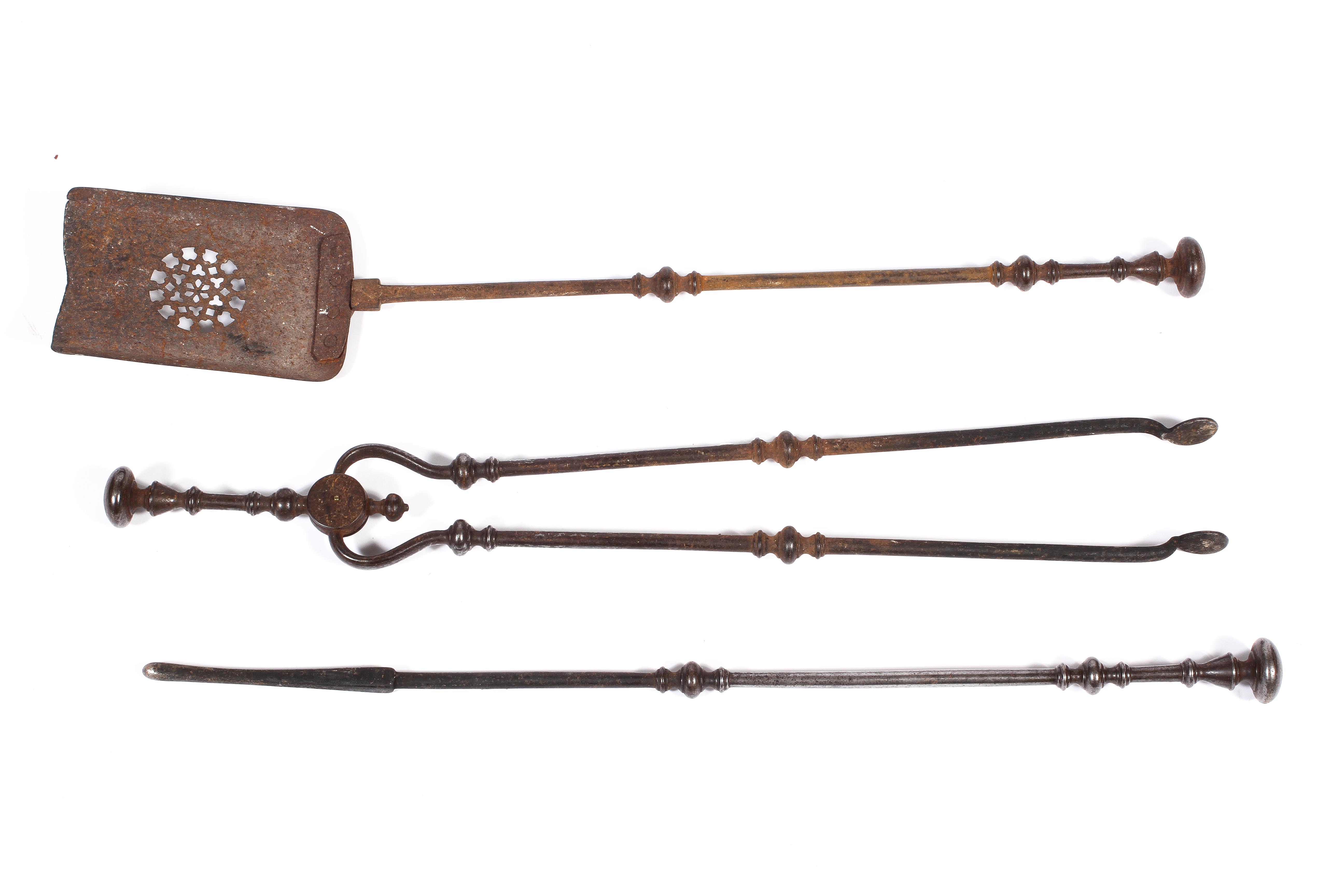 A set of Georgian steel fire tools, comprising: a poker, tongs and a shovel, with knopped handles,