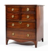 A Georgian mahogany pot cupboard, the moulded top above two panelled doors above a cupboard,