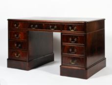 A Victorian mahogany twin pedestal desk, the moulded top inset with tooled green leather,
