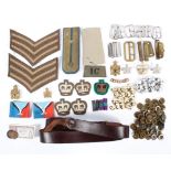 A collection of assorted 20th century military buttons and cloth badges and shoulder stripes