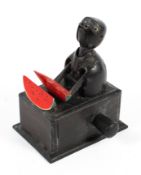 A vintage novelty carved wooden figure, modelled as a man eating a watermelon, on ebonised base,