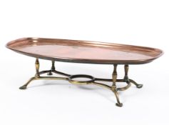 An Arts and Crafts copper and brass footed warming tray, after a design attributed to WAS Benson,