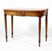 A 19th century mahogany flip top table with black banded inlay raised on turned legs,