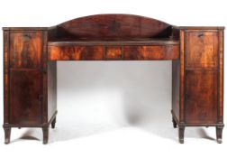 An early 19th century mahogany sideboard, the D-shaped top with reeded front and two frieze drawers,