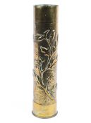 A brass trench art shell case with floral decoration,