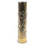 A brass trench art shell case with floral decoration,