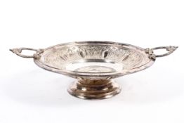 A silver plated circular footed dish with loop handles and repousse decoration,