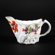 A English porcelain cream jug, circa 1765, possibly Derby, wrythen moulded with leafy branches,