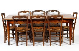 A cherry wood dining table and eight rush seated chairs, 20th century,