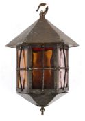 An Arts and Crafts copperised ceiling lantern, with planished decoration with six glass panels,