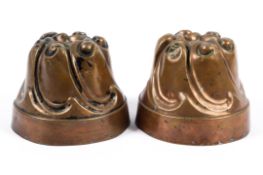 Two Victorian copper jelly moulds, with scroll cast tops,