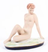 A Royal Dux porcelain model of a reclining female nude, 20th century, applied pad mark,