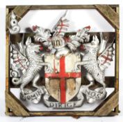 A large carved and painted wooden coat of arms representing the St George's Cross,