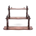 A Victorian mahogany hanging three tier shelf, of serpentine outline,