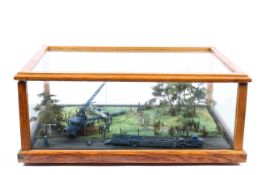 An oak and glass cased scratch built military diorama of a crashed German Stuka with rescue team