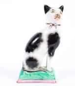 A Staffordshire pottery model of a cat, late 19th century,