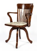 A 1920's mahogany desk chair, with pierced back and scroll arms,