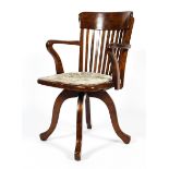 A 1920's mahogany desk chair, with pierced back and scroll arms,