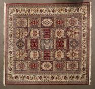 A large Oriental style wool floor rug red ground with cream floral border,