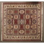 A large Oriental style wool floor rug red ground with cream floral border,