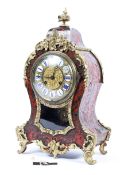 A French Boulle work gilt-metal mounted striking mantle clock, late 19th century, of scroll outline,