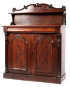 A Victorian mahogany chiffonier, mid-19th century, with foliate scroll carved back and shelf,