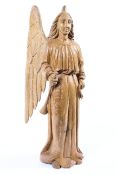 A large contemporary carved oak sculpture of an angel, modelled standing wearing long robes,