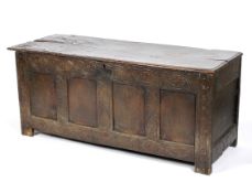 An oak coffer, 17th century, of panelled construction,
