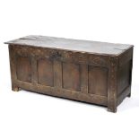 An oak coffer, 17th century, of panelled construction,