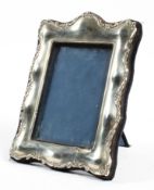 A contemporary silver mounted picture frame with easel and felt back,