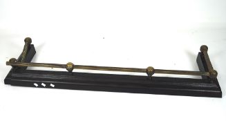 A 19th century cast iron and brass fender, the brass with a fluted design,