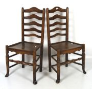 A pair of Victorian kitchen chairs, both with shaped slats, with turned supports and cabriole feet,