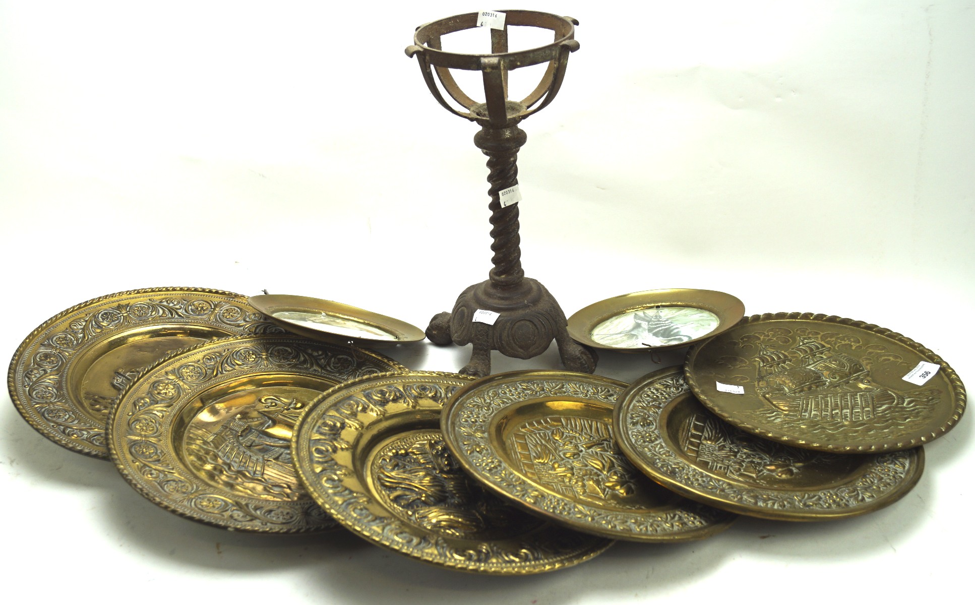 A selection of 20th century brass chargers and a metal stand,