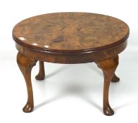 A 20th century burr walnut coffee table, of circular form, supported on cabriole feet,