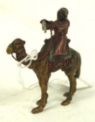 A 20th century cold painted Bronze depicting an Arab warrior mounted upon a camel,