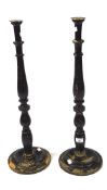 A pair of early 20th century candlesticks, the turned wooden uprights mounted on a circular base,