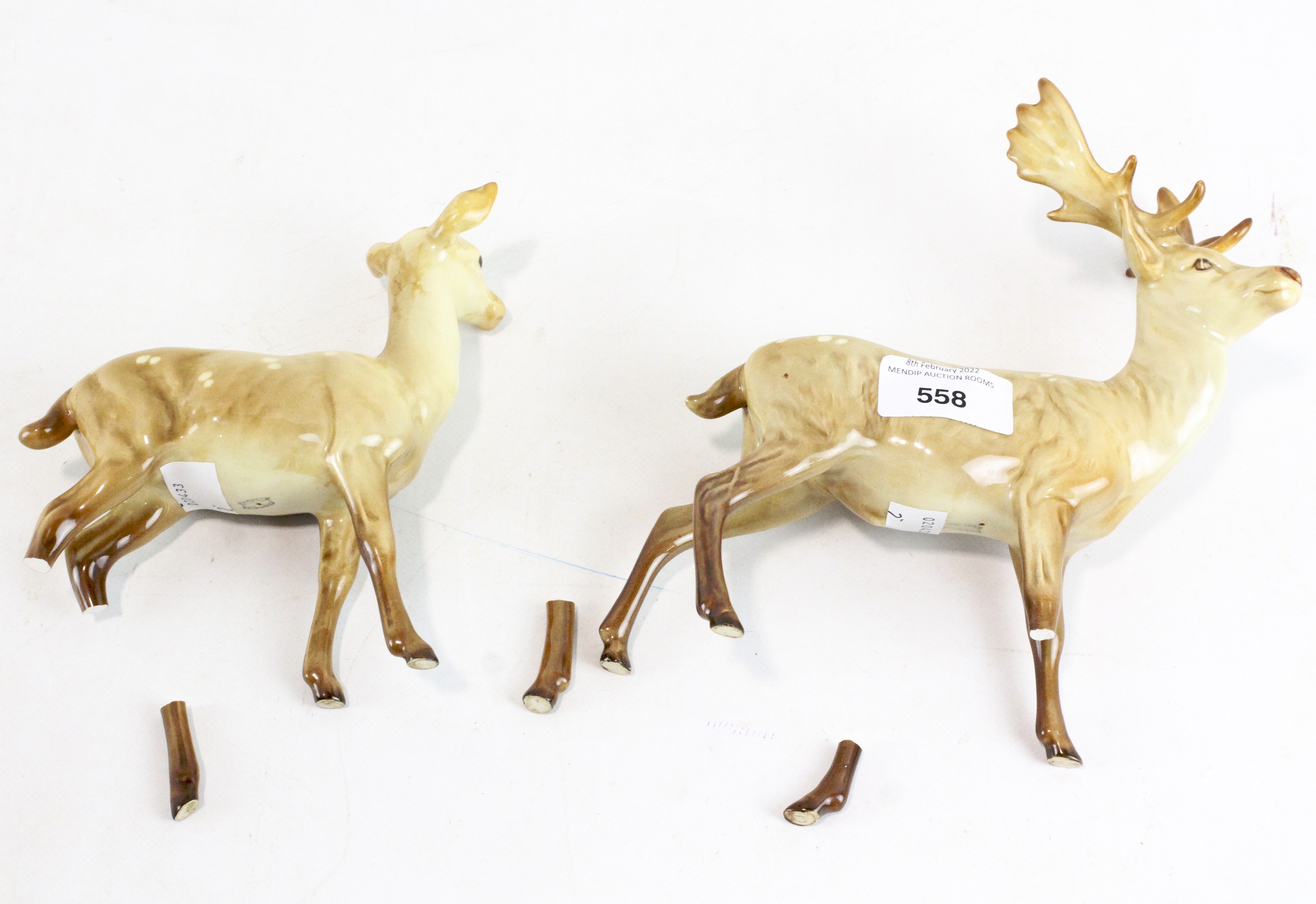 Two Beswick ceramic figures of deer, one being a stag, the other a doe, largest 19.
