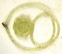 A contemporary carved white jade pendant, in the form of a flower,