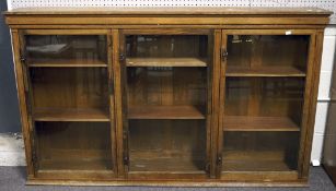 A 20th century wooden bookcase, split into three sections,