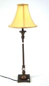 A contemporary table lamp, the gilt metal frame supported on a square base,