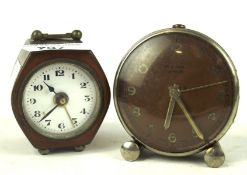 Two small vintage alarm clocks, one being a Cyma Amic,