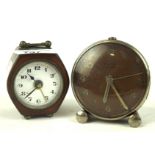 Two small vintage alarm clocks, one being a Cyma Amic,